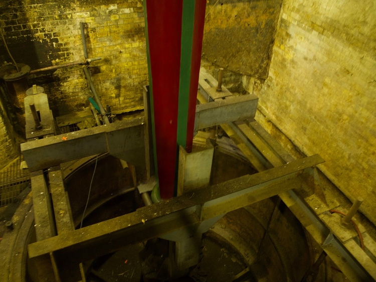 A piston-like machine, with the top painted in red and green.