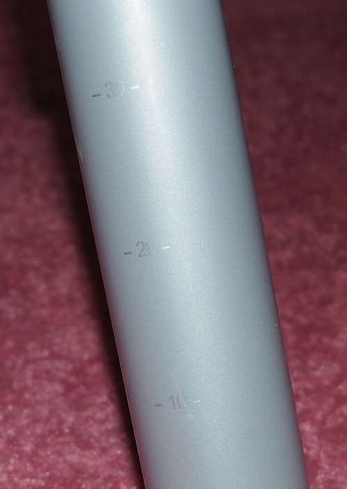 A grey cylindrical table leg, with markings 10/20/30.