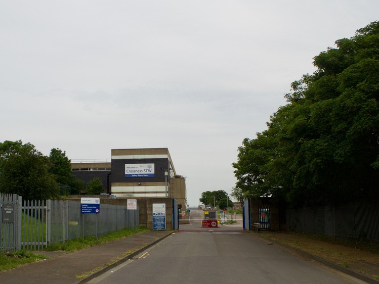 A square building labelled “Crossness STW”, with fences and a road barrier.