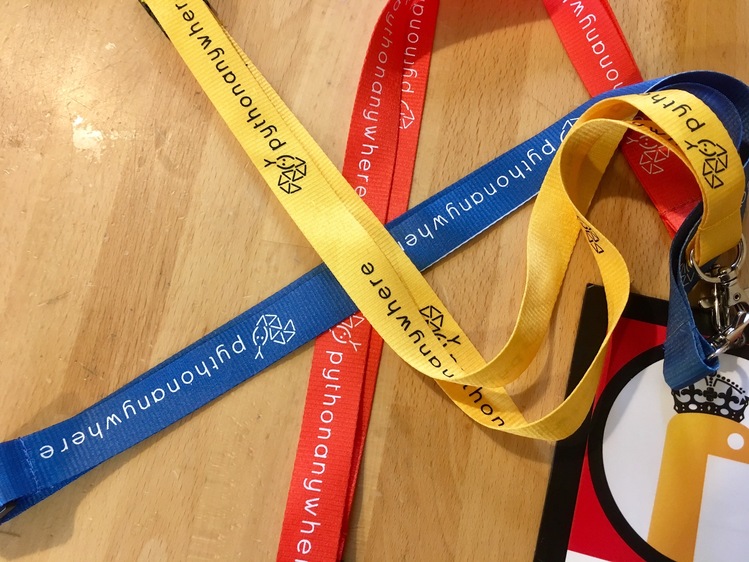 The red, blue and yellow lanyards attached to a partially in-shot badge.
