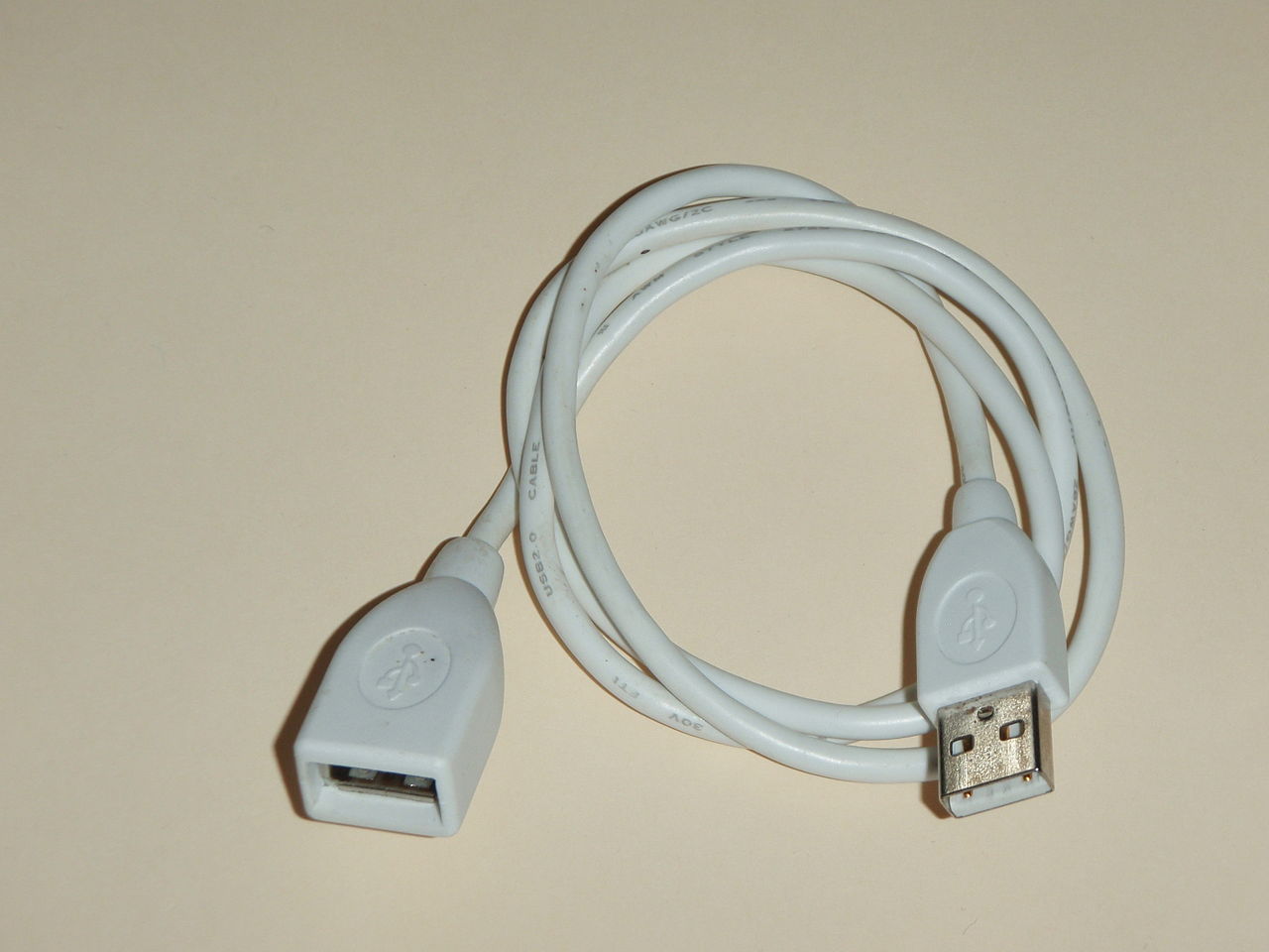 A grey cable with a USB plug at one end, and a socket at the other.