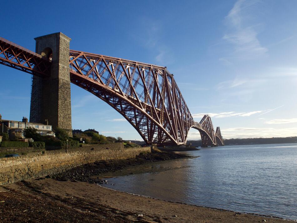 The bridge crossing the frame, set against a blue sky.