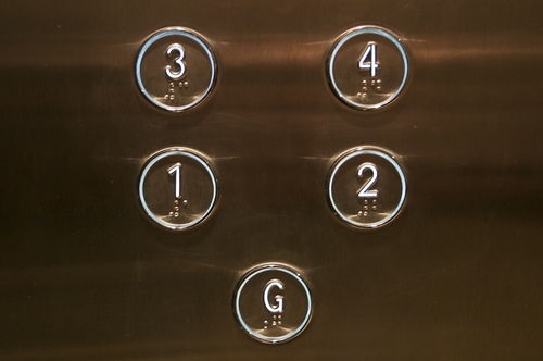 Buttons in a lift with printed numbers and braille inscriptions.