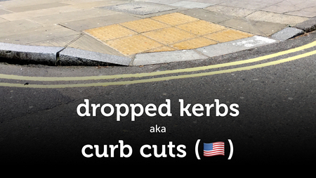 A dropped kerb against a black background, with the caption “dropped kerb aka curb cut”.