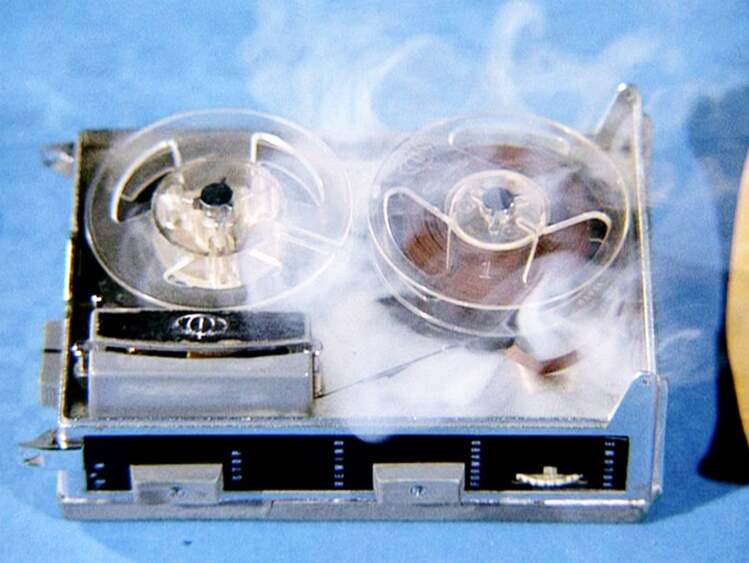 A tape recorder with smoke coming out of it.