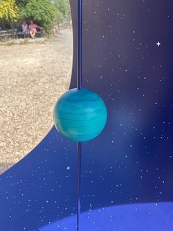 A close-up of the Uranus model, which is a turquoise sphere with some gentle blue lines across the surface. It's quite a simple and calming planet.