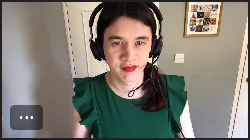 A thumbnail of me on a video call. Behind me is a featureless grey wall, a white door, and a wooden-framed picture with indistinct coloured squares.