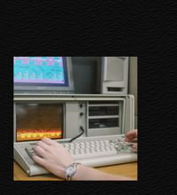 Screenshot of the site with a dark background, an image of a computer but no banner.