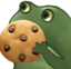 A green cartoon frog holding up a cookie